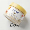 A jar of Dove exfoliating body polish with a yellow lid and light beige scrub inside.