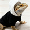 A bearded dragon costume featuring a realistic head and body, dressed in a black shirt and white hood.