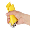 A hand is holding a yellow soft silicone dog muzzle with an adjustable fit and a metal clip.