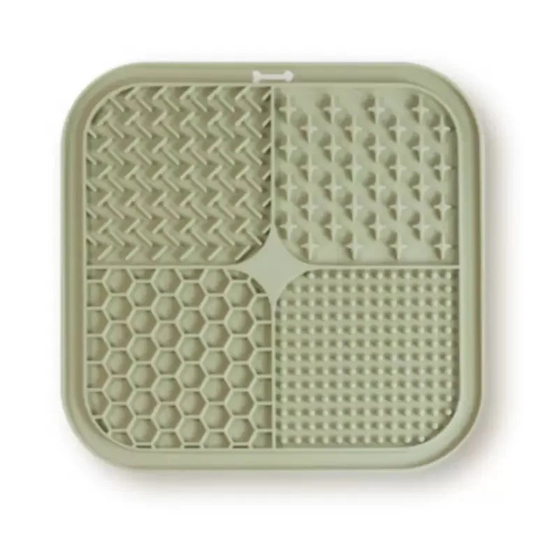 A silicone pet licking mat with suction cups divided into four sections for slow feeding dogs and cats.