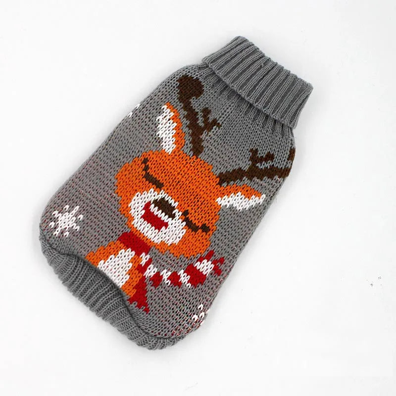 A knitted winter dog sweater featuring an orange and white fox design on a gray background.