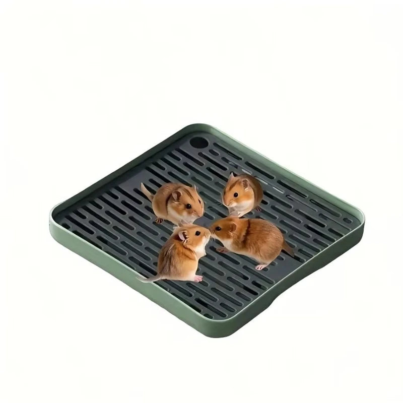 A green pet litter box tray with small, light brown animals inside.