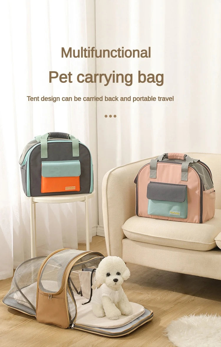 A pink pet carrying bag with a grey backpack design is shown next to a beige sofa and a transparent carrier on the floor.