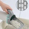 A hand is using an integrated pet waste scoop and cleaner to scoop dry pet waste from a bowl.