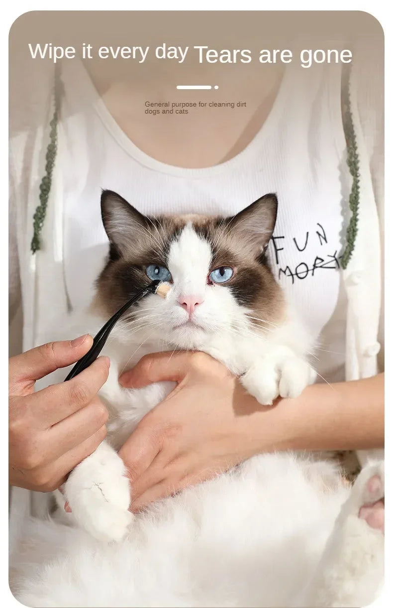 A cat is being groomed with a black brush, demonstrating the use of a pet tear stain remover for dogs and cats.