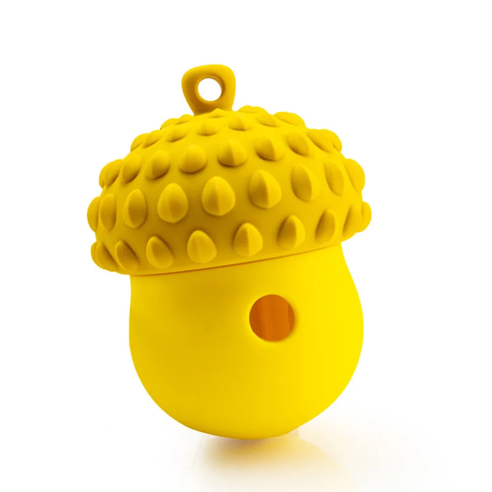 A bright yellow interactive slow feeder puzzle toy for dogs and cats with a textured dome and a hole.