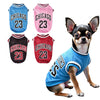 A chihuahua wearing a blue basketball vest with Chicago 23 lettering, alongside three similar pink and red vests.
