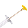 Yellow parrot feeding syringe with soft hose and clear plastic tip