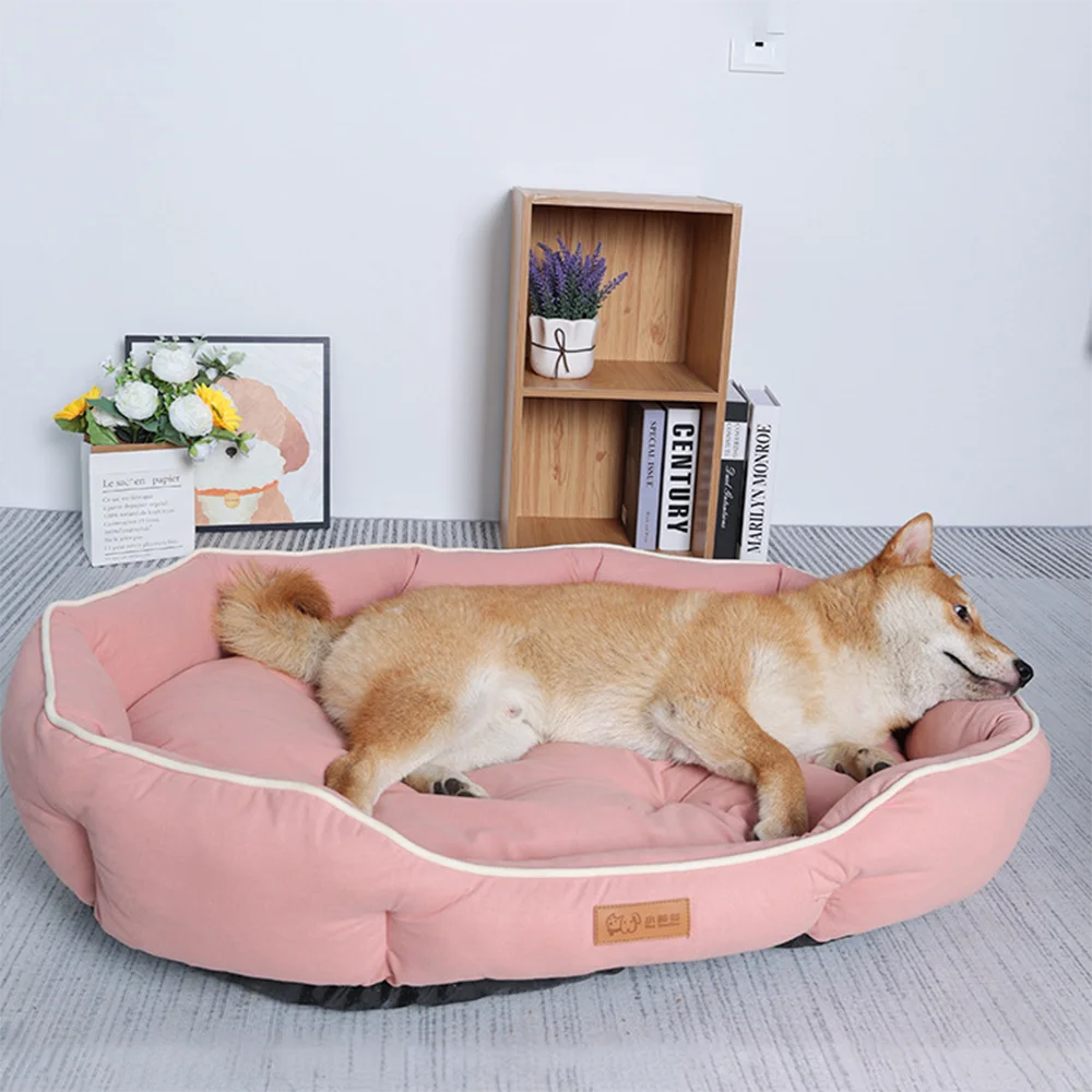 A light brown dog is lying on a pink luxurious corduroy pet sofa bed in a modern room.