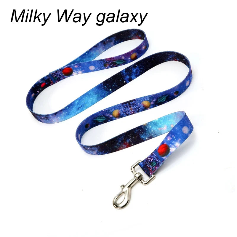 Blue and purple Milky Way galaxy patterned fabric dog leash with a metal D-ring.
