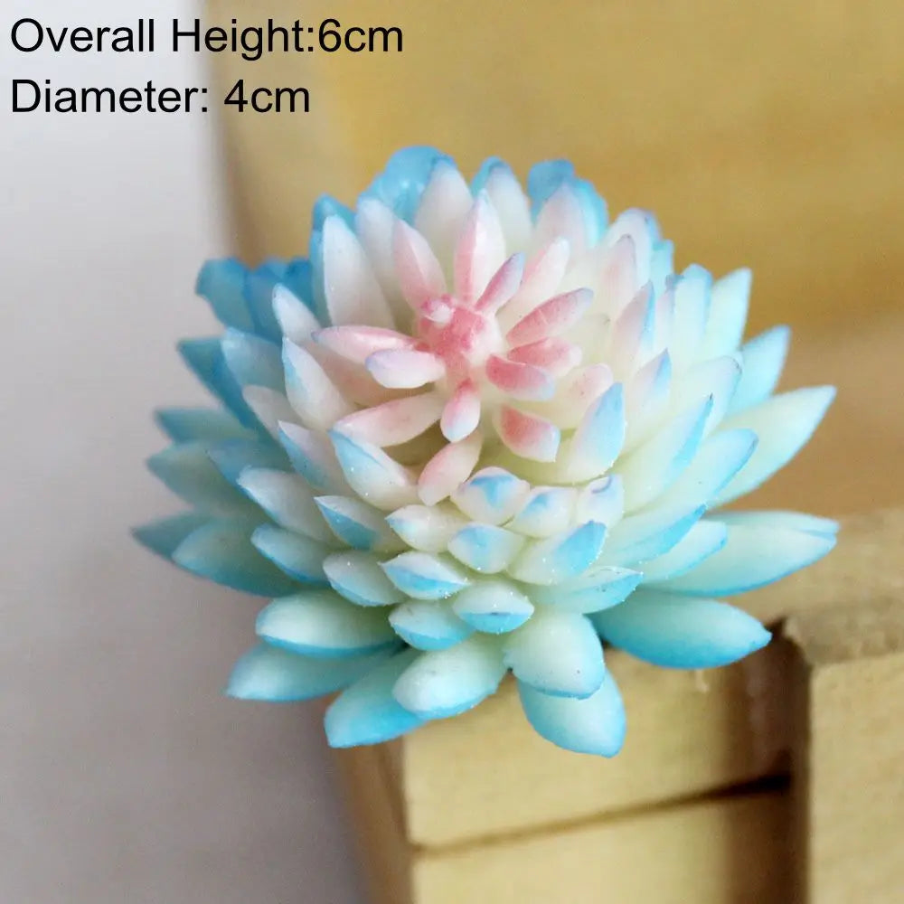 A light blue and pink artificial succulent plant with a layered, rosette shape displayed on a wooden surface.