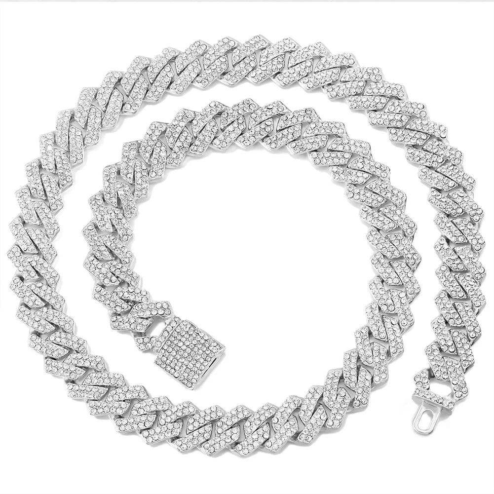 A silver iced out Cuban link chain necklace featuring rhombus diamond accents.