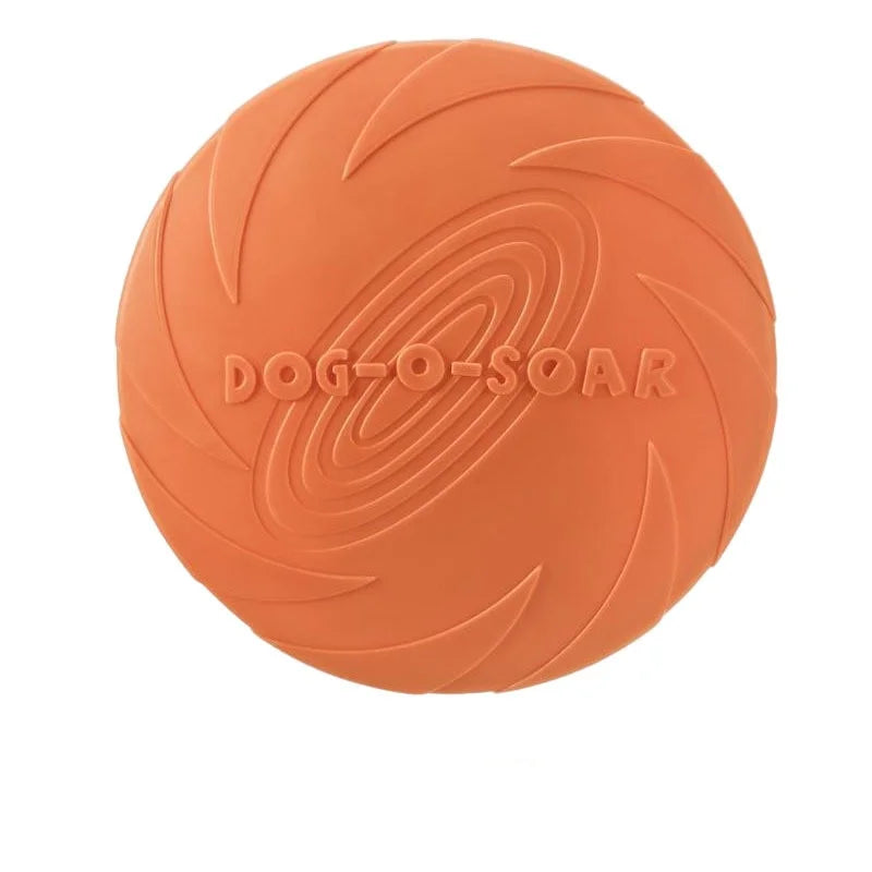 An orange silicone flying disc with swirling patterns for dogs.