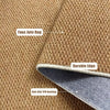 Close-up view of a brown faux jute rug with a durable edge and anti-slip TPR backing.