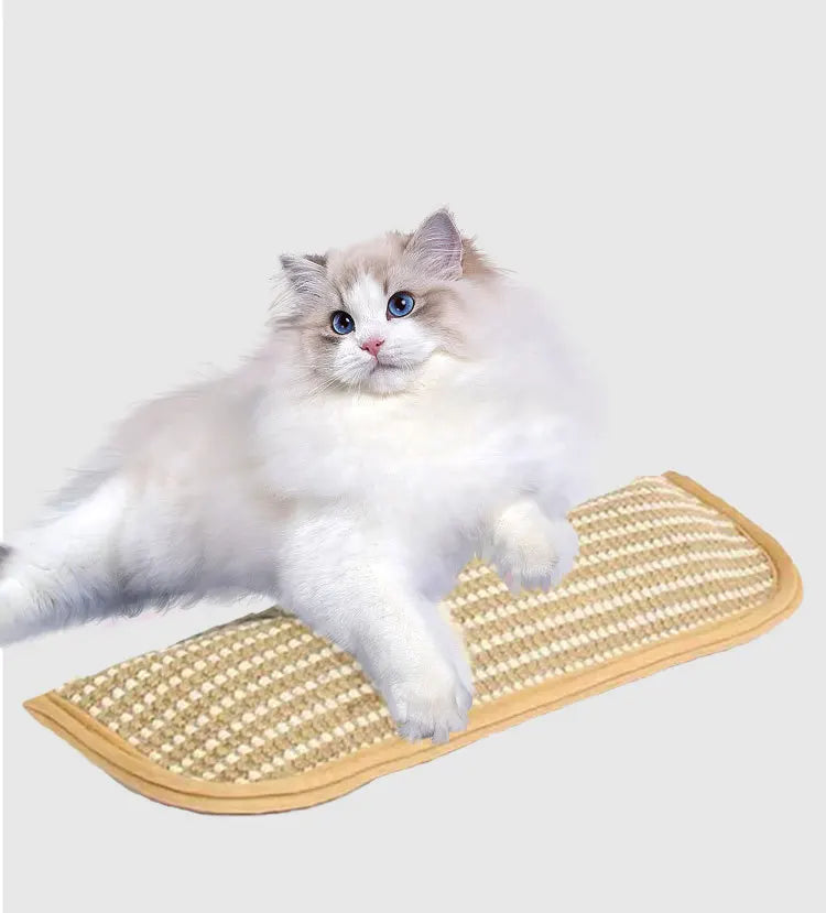 A fluffy blue and white cat is lying on a beige multi-functional cat scratcher mat.