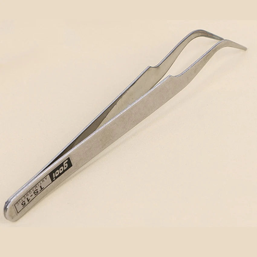 A pair of silver precision tweezers with a T5-15 marking.