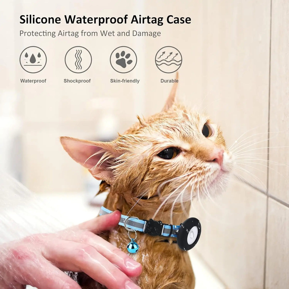 A ginger cat is wearing a silicone waterproof AirTag collar holder on its neck, being held by a human hand.