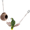A natural coconut shell bird nest hanging from a cord, with a green parrot perched on it.