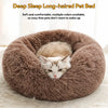 A fluffy brown pet bed with a cat sleeping inside.