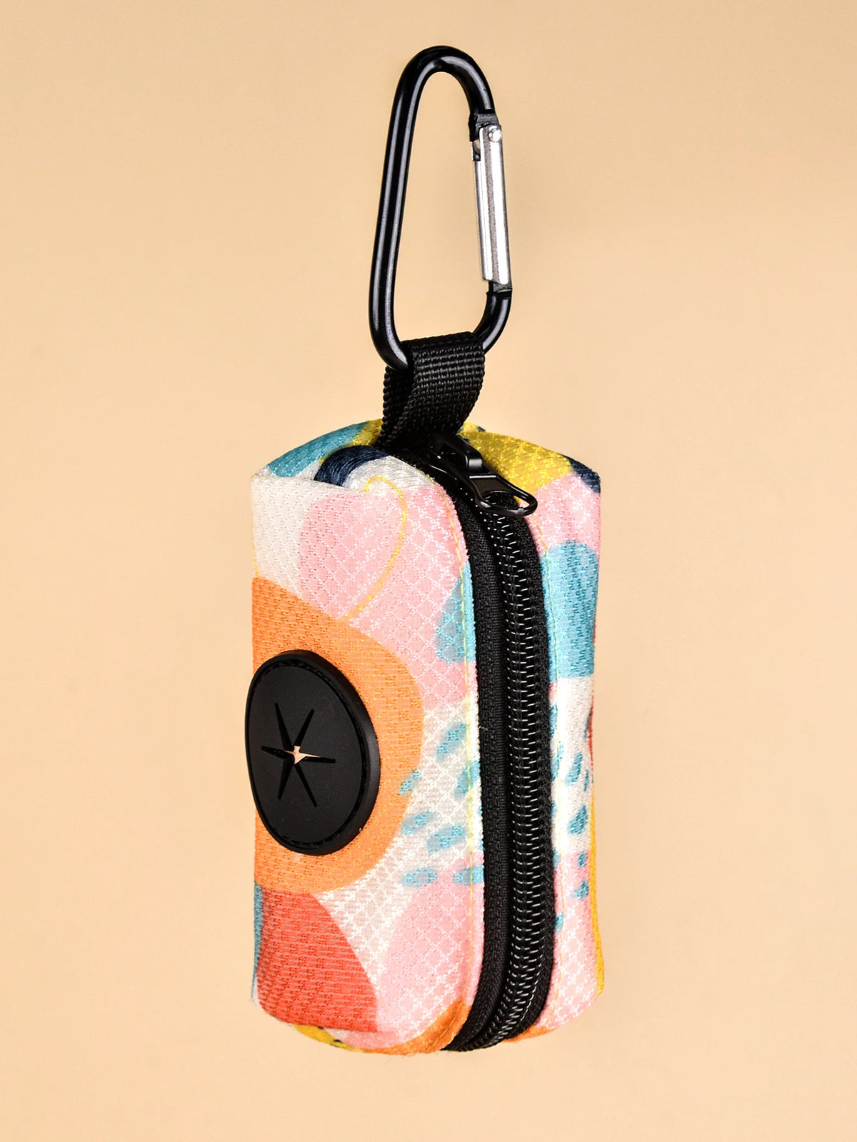 A colorful fabric poop bag dispenser with a black clip and zipper on a light beige background.