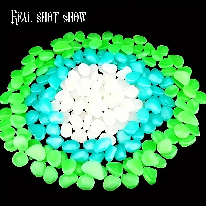 A circular arrangement of glow-in-the-dark decorative stones in shades of green, blue, and white.