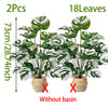 Two artificial monstera plants with variegated green and white leaves shown without a decorative basin.