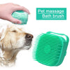 A hand is using a green silicone pet massage bath brush on a dog's head.
