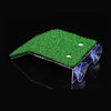 A clear platform with a green grass ramp and suction cups is shown against a black background.