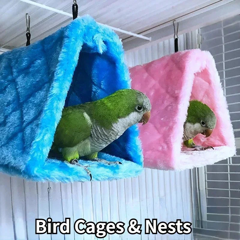 Two plush hanging bird hammocks or nests in blue and pink colors.
