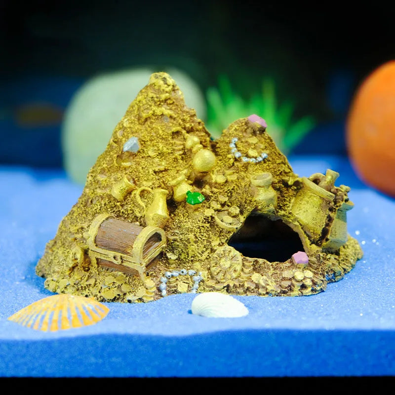 A golden mountain cave hideout decoration featuring a treasure chest entrance and small sea shells.