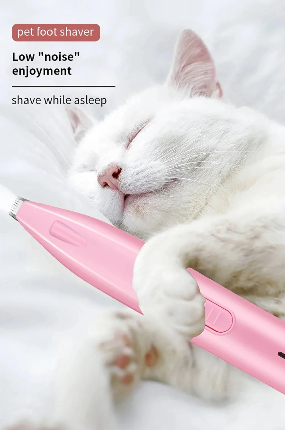A pink pet foot shaver is being used on a sleeping white cat's paw.