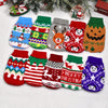A collection of knitted winter dog sweaters in various patterns and colors displayed on a white background.