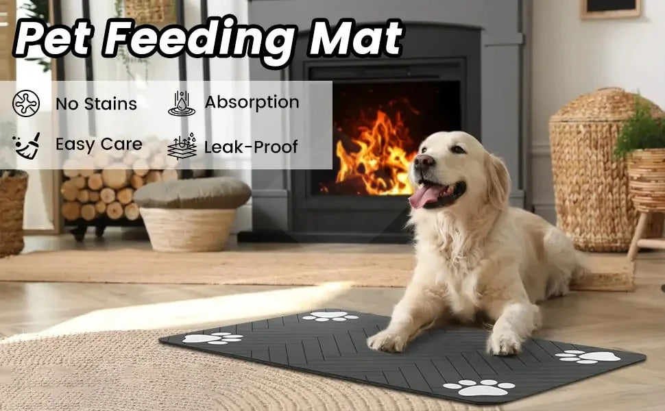 A golden retriever dog lies on a black pet feeding mat indoors next to a fireplace.