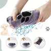 Hands are holding a purple pet bath towel with paw prints, demonstrating its use for washing pets.