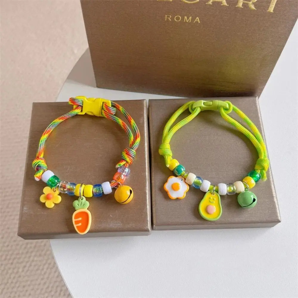 Colorful braided pet collar with a bell for cats and small dogs displayed in a box.