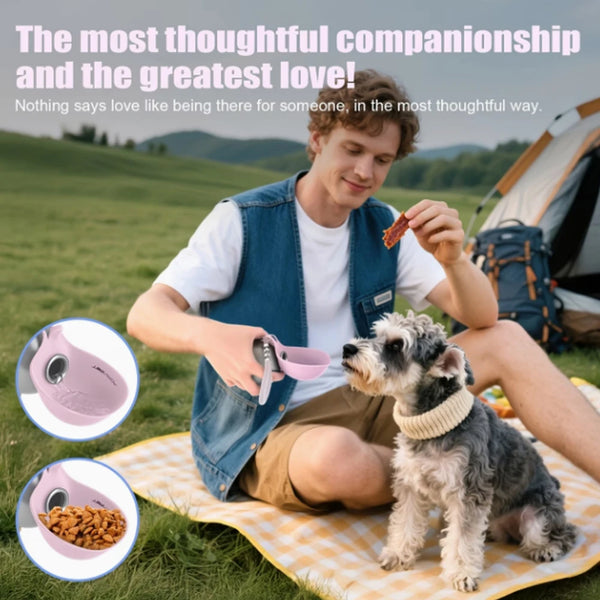 A young man is sitting outdoors with a dog, holding a pink portable water bottle and a treat.