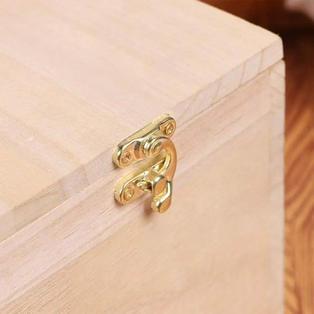 Gold brass latch hardware on a light wood bird nesting box.