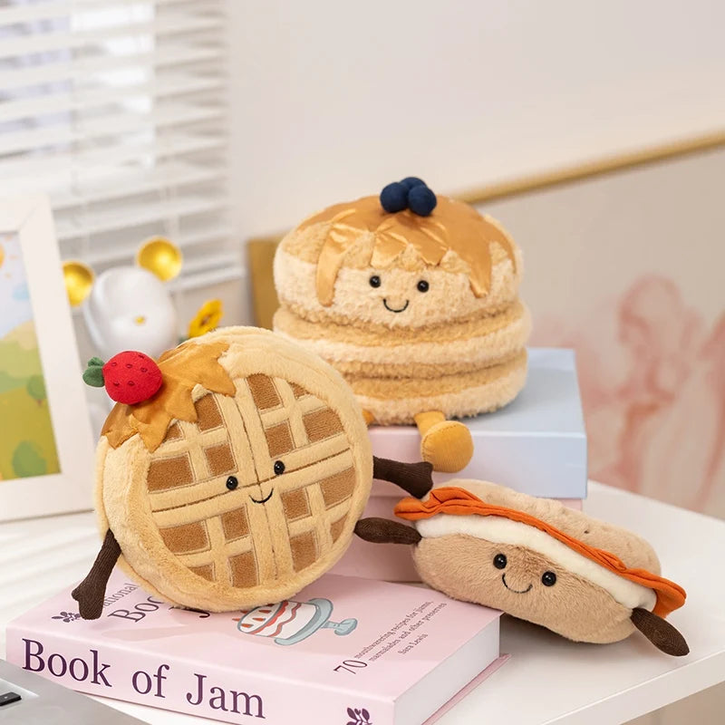 A collection of adorable dessert plush toys, including a cake and a tart, displayed on a white surface.