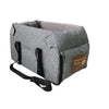 A gray portable pet car seat carrier for small dogs and cats with a brown tag.