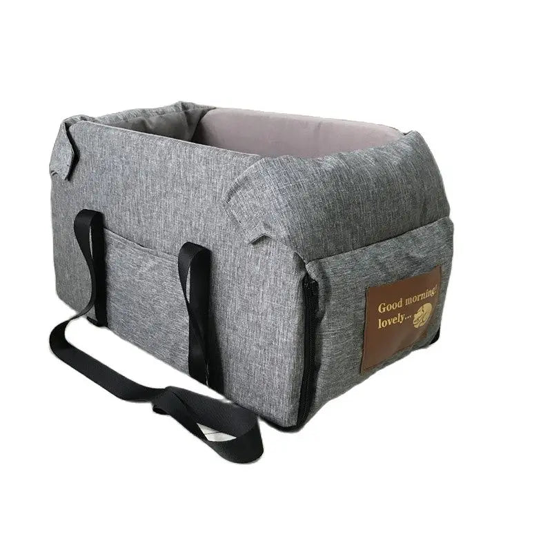 A gray portable pet car seat carrier for small dogs and cats with a brown tag.