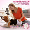 A young woman is smiling while holding a pet in an absorbent disposable diaper for puppies.