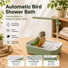 A green automatic bird shower bath with a flowing water feature is shown next to a bird.