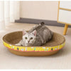 A gray cat is resting inside a round, woven scratching post with yellow and green accents.