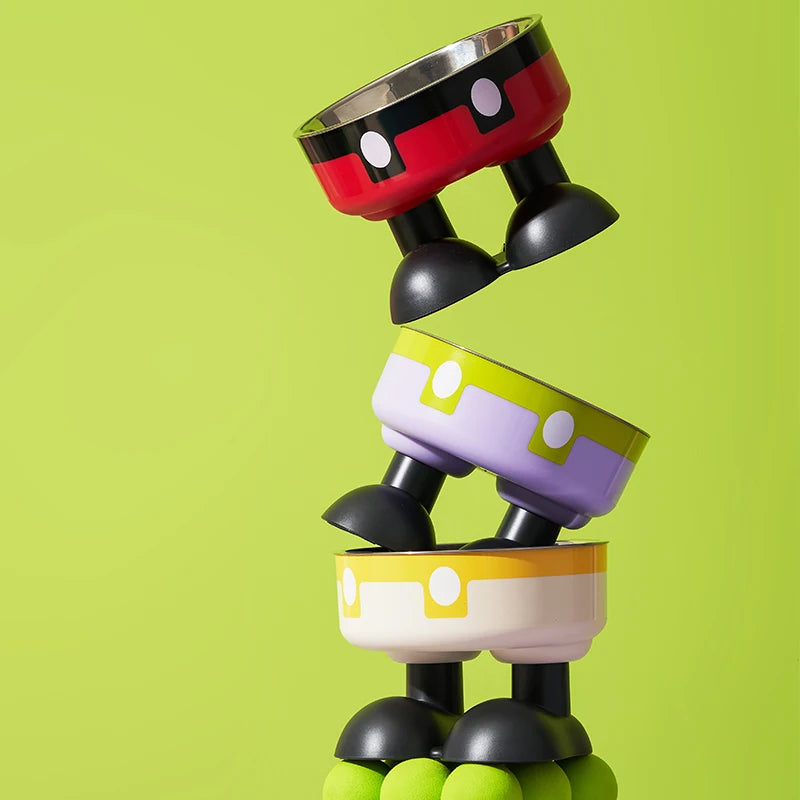 A stack of colorful elevated stainless steel pet bowls in red, purple, and yellow shades.