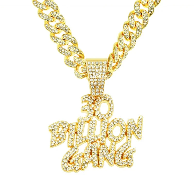 A gold iced out letter and animal pendant Cuban link chain necklace