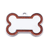 Silver pet ID tag shaped like a bone with an orange glitter border
