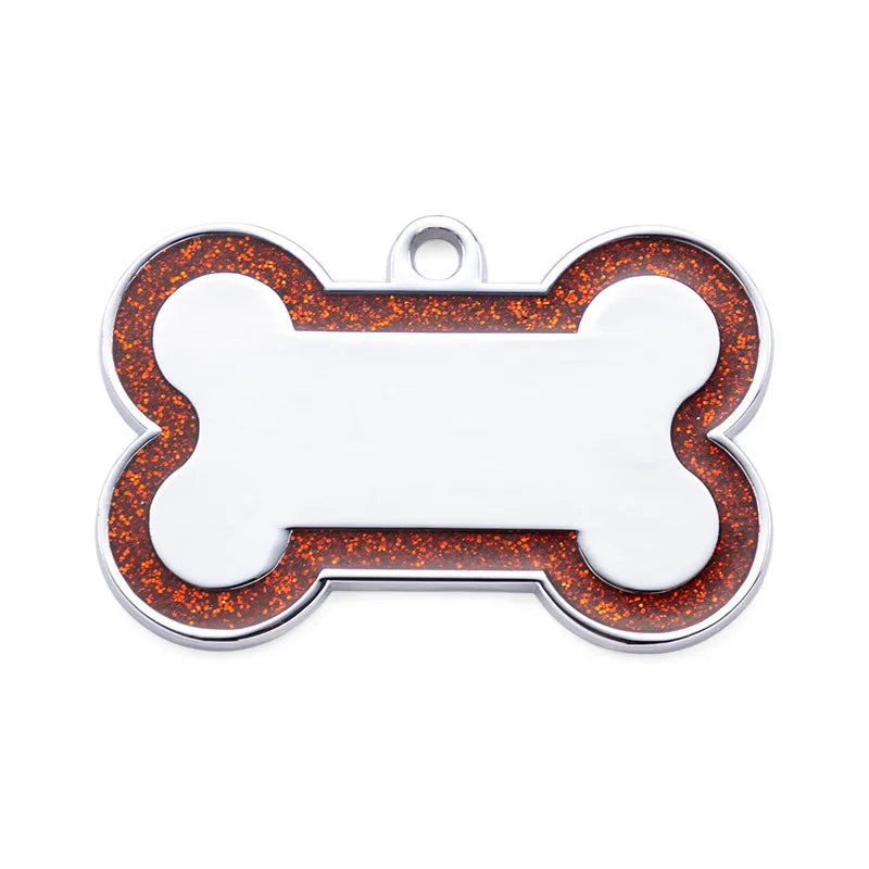 Silver pet ID tag shaped like a bone with an orange glitter border