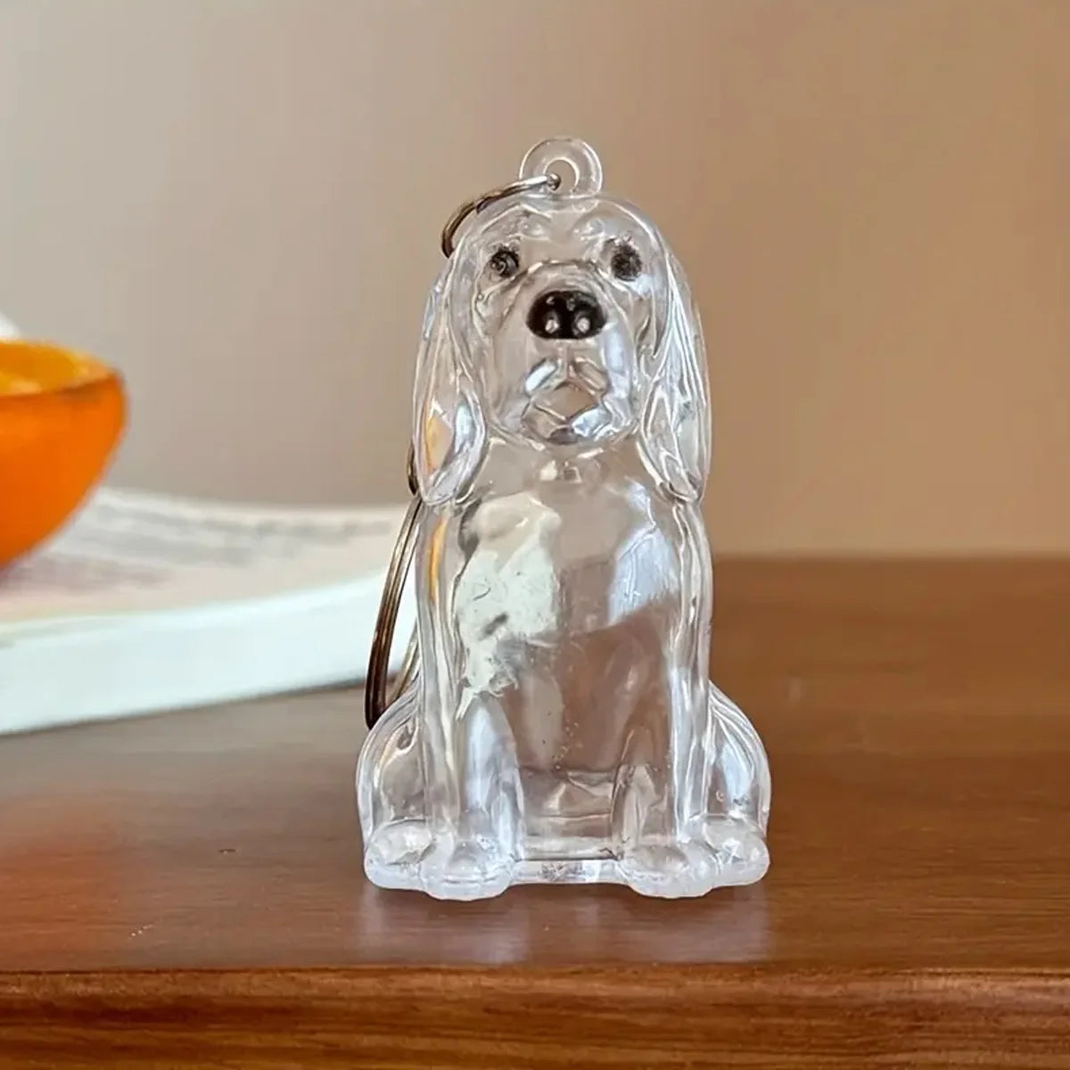 Clear glass keychain featuring a dog design, depicting a seated dog with floppy ears and a collar.