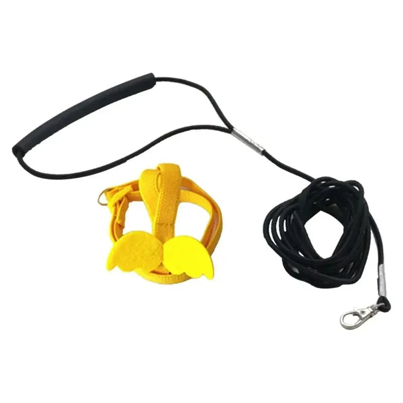 Yellow parrot flying harness with a black strap and cord.