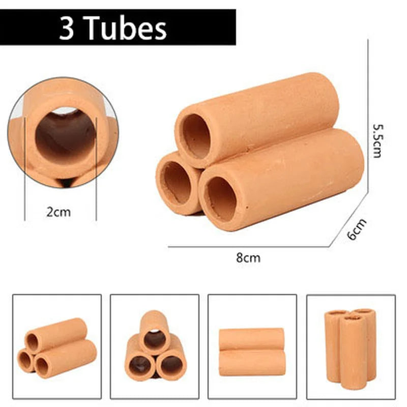 Three cylindrical tubes of natural clay used as aquarium cave decoration for fish and shrimp.
